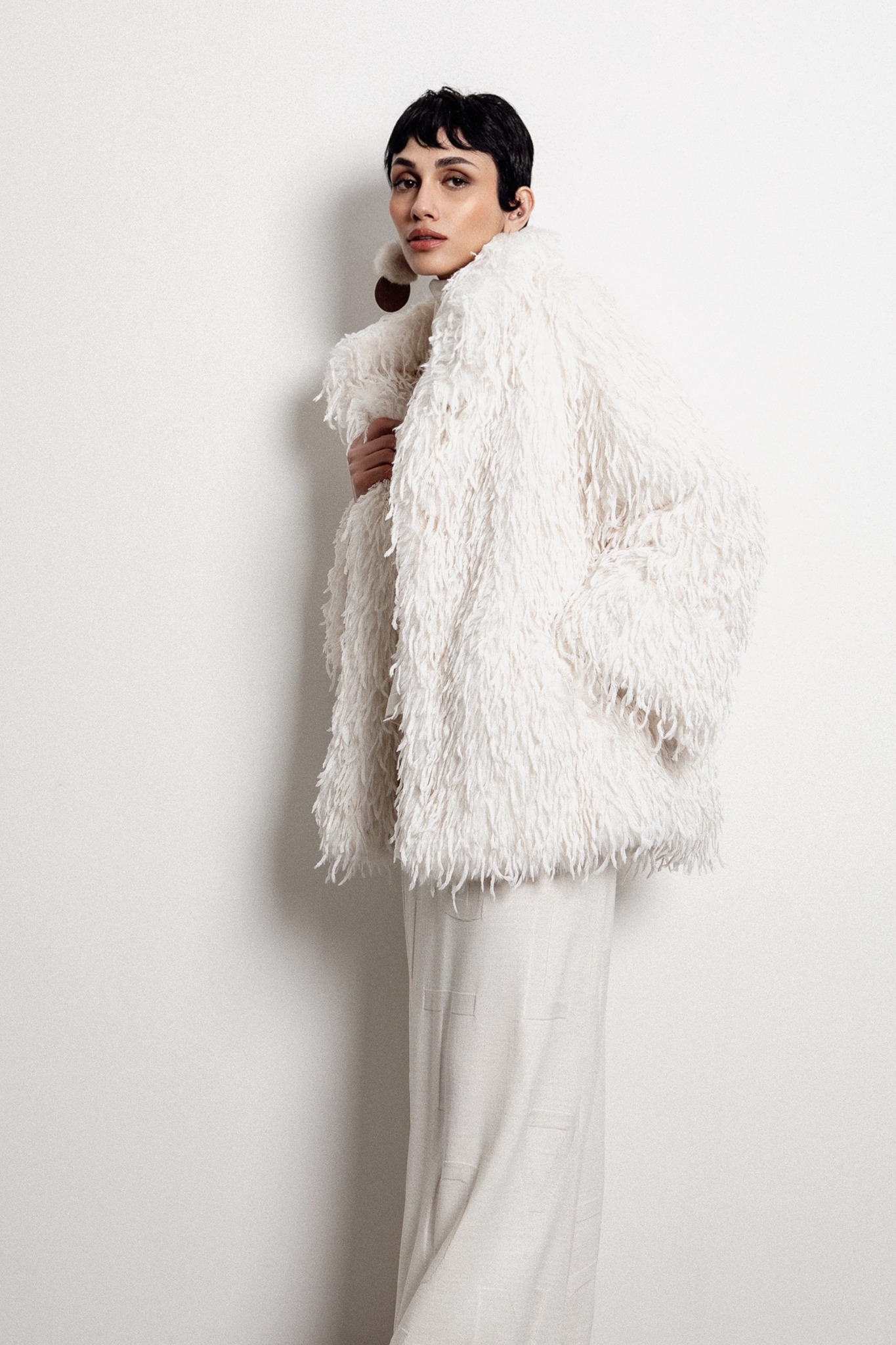 Model in white outerwear with a textured finish